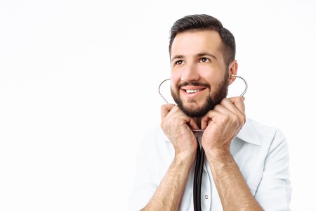 Portrait of a young hipster doctor, on a white background, Intern in the Studio, with a stethoscope on the neckの写真素材