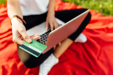 man working with laptop computer, Hands typing on keyboard, and advertising credit card