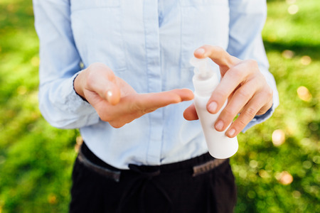 antibacterial agent in hand. the concept of purity and health, girl, holds in her hand, a white can,