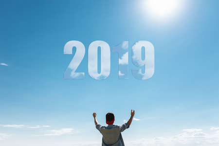 Man, against the blue sky, the guy pulls hands to the sky, the concept of the new 2019 year. Christmasの写真素材