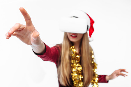Portrait of a young girl in a Santa Claus hat with glasses, 3D glasses. on a white background.の写真素材