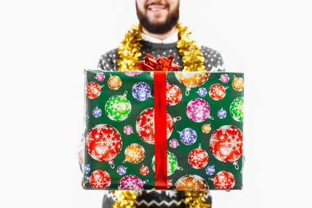 A man with a Christmas gift in his hands