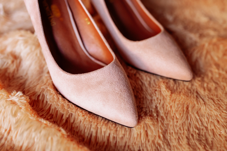 Image of stylish elegant classic beige shoes, against a wooden texture background.の写真素材