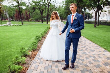 beautiful young wedding couple in natureの写真素材