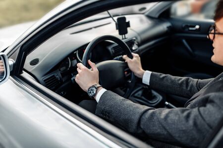 Business young businessman driving a car, going to workの写真素材