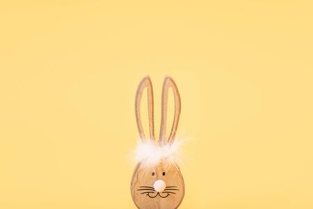 Wooden Easter Bunny, on an isolated yellow background. The Concept Of Easterの写真素材