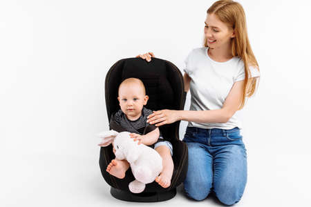 Baby in baby car seat, with mom on isolated white background