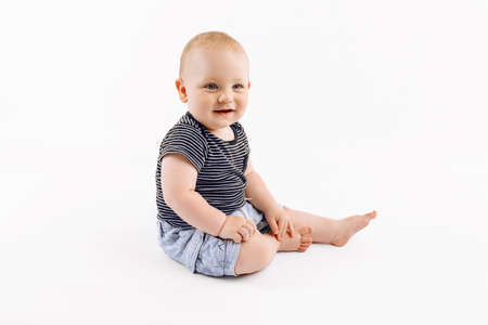 Little happy cute boy, kid is played on isolated white backgroundの写真素材