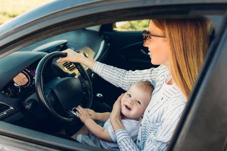 Happy family on the road in their car, mom and child travel, summer trip by carの写真素材