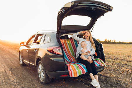 Family holiday and travel concept, summer vacation, happy family, mom and child enjoying the trip by carの写真素材