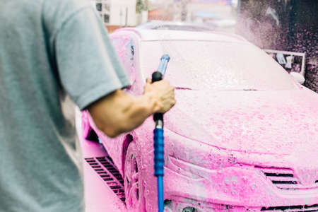 Manual car wash with pressure water on the street, Summer car wash, Car wash with high pressure...