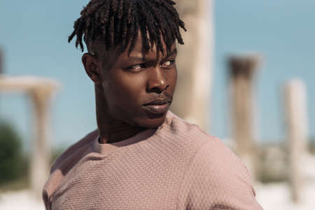 Portrait of handsome fashionable black african man, with afro hairstyle, model in stylish clothes...