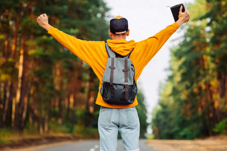 Christian man with outstretched hands holds a Bible in the open air. Faith, freedom, spirituality and religion concept. Peace, hope.の写真素材
