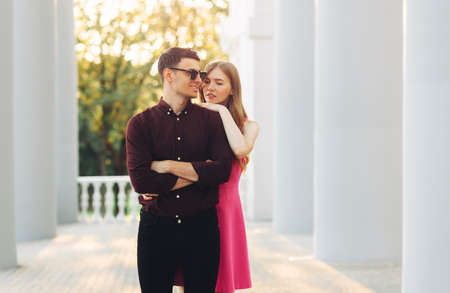Image of a happy beautiful young couple in love, dating in the city outdoors. Romantic couple walking in the city holding hands, celebrating Valentine's Day, February 14の写真素材