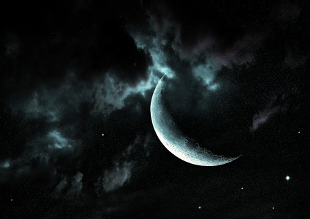 The moon in the night sky in cloudsの写真素材