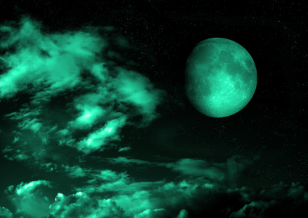 The moon in the night sky in cloudsの写真素材