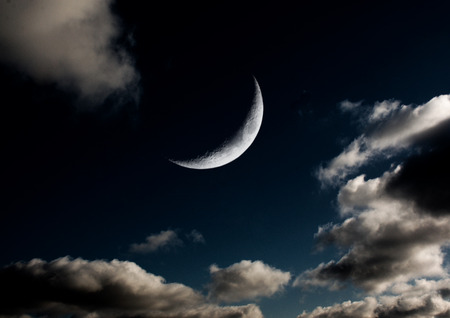 The moon in the night sky in clouds 3D illustrationの写真素材