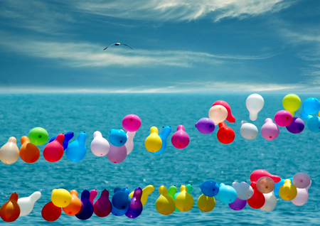 colorful hot air balloons over the sea surfaceの写真素材