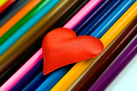 One red, identical heart on a multi-colored backgroundの写真素材