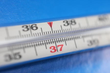 Medical thermometer on blue background. Temperature 37.