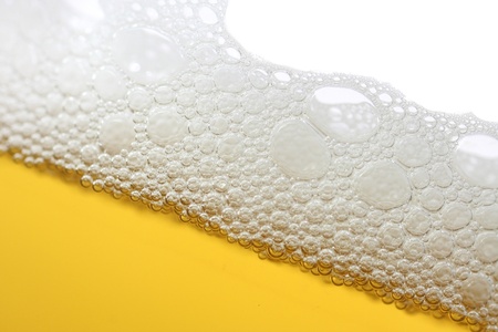 A close-up image of a beer with a foam head.の写真素材