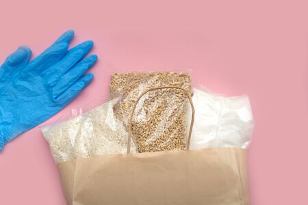 Food supply crisis food stock quarantine period isolation on a pink background. Rice, barley, sugar....