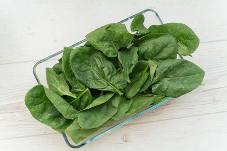 spinach in a transparent bowl on a light background. Healthy eating concept.の写真素材