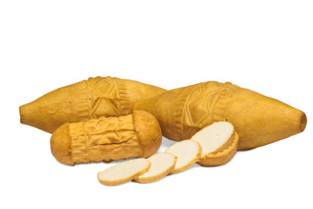 Traditional Polish smoked cheese - oscypek on white backgroundの写真素材