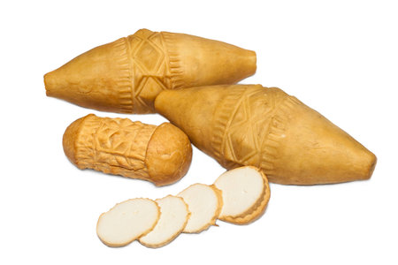 Traditional Polish smoked cheese - oscypek on white backgroundの写真素材