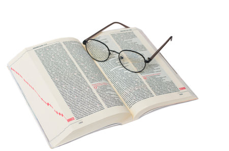 Glasses lying on the Bible in Polish isolated on a white backgroundの写真素材