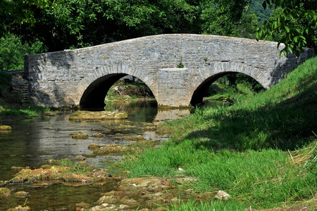 bridge over a quiet streamの写真素材