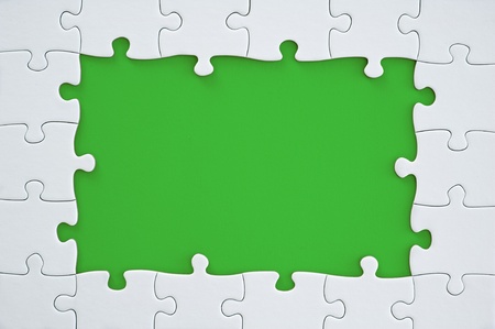 White Puzzle Frame on green Backgroundの写真素材