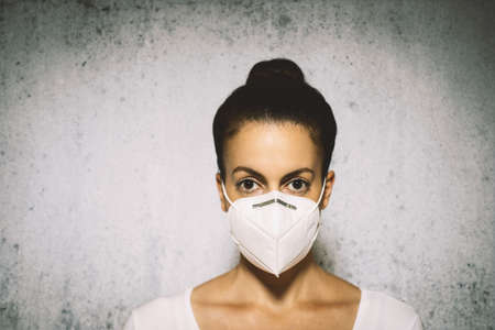 Woman wearing a respirator mask device for health protectionの写真素材