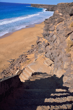 stairs on the  beach of ocean and rock cost of island Fuerteventura の写真素材