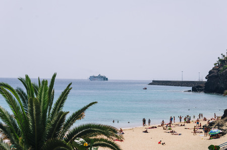 crowd beach and port. Morro Jable. Fuerteventura. Summer vibes. relax zone.の写真素材