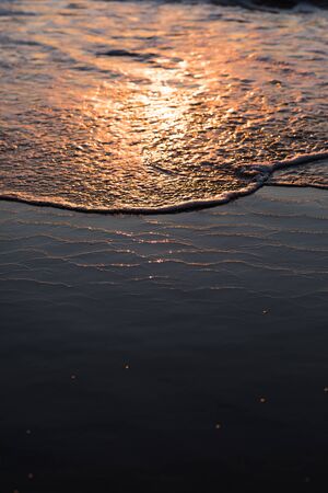 nature poster. surf ocean. splah of wave at orange sunset. boke of water drops