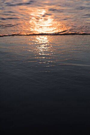 nature poster. surf ocean. splah of wave at orange sunset. boke of water dropsの写真素材