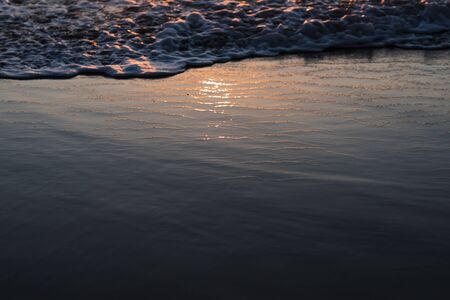 nature poster. surf ocean. splah of wave at orange sunset. boke of water dropsの写真素材