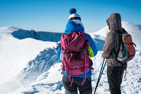 girls walking on snowy mountainsの写真素材