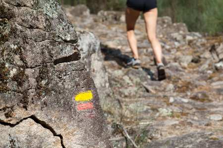 tourist signs on the trail in the mountains - running girlの写真素材