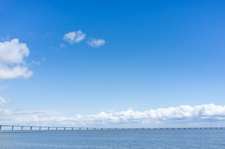 Long bridge in the sea, Beautiful summer sky with a minimalist bridge, Background with bridge, Summer positive background architectureの写真素材