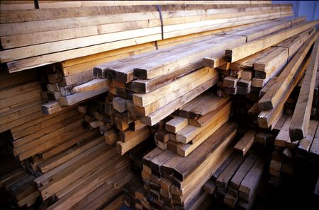 stocks of wood piled beside eachother in a construction site