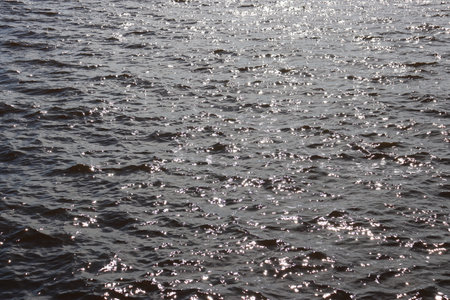 Blue water texture. Ocean and ripples on the water on a sunny summer day.の写真素材