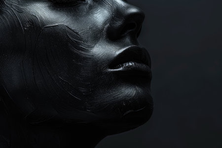 Black woman face on black background with closed eyes, sensation. Oil waves. High quality photoの素材