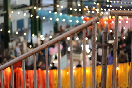 Metal handrail close-up, exhibition in the background, blurry. High quality photoの写真素材