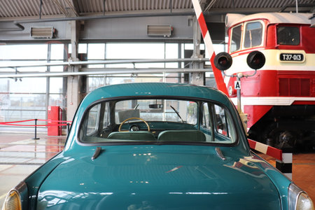 A small vintage retro car stands and train at a railway crossing. High quality photoの写真素材