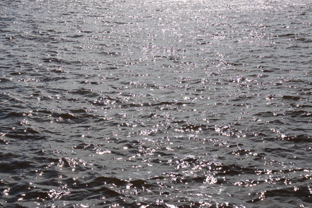 Blue water texture. Ocean and ripples on the water on a sunny summer day.の写真素材