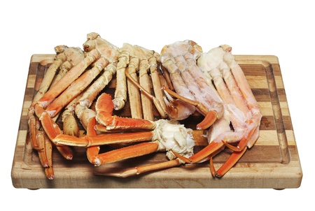 Crab legs on a cutting board isolated on whiteの写真素材
