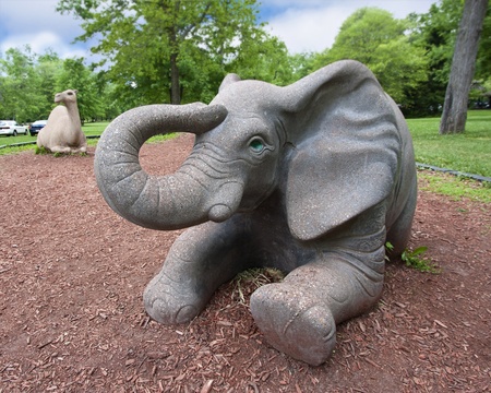 A large elephant statue in a children's playground の写真素材