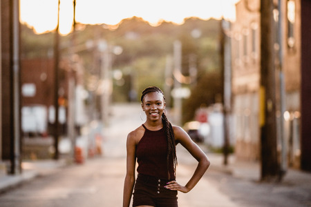 One African American girl poses for her senior portraits. Teen fashion. Teenage model.の写真素材